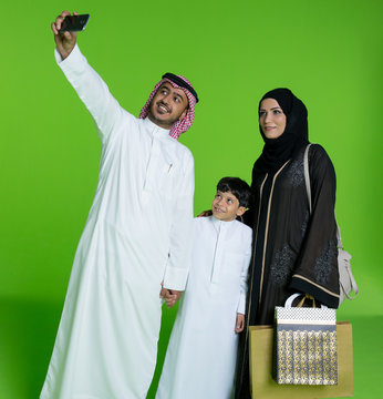 Arab Family Taking Selfie Using Mobile Camera.