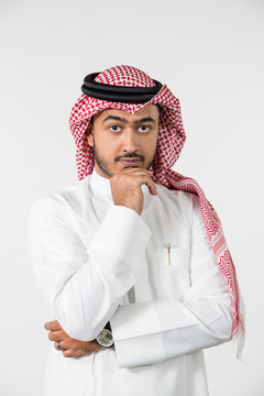 Portrait of Arab man with hand on chin.