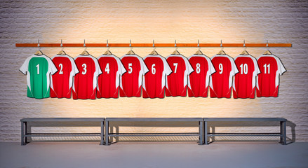 Row of Red and Green Football Shirts hanging on Wall in Changing Room with Bench