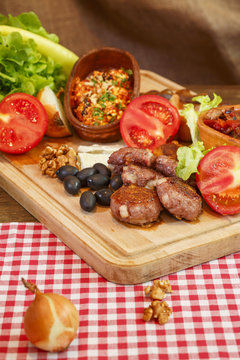 Meat burgers and vegetable.Stew in pot on wooden plank