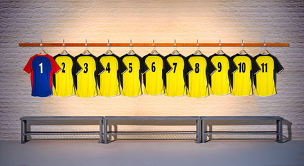 Row of Yellow and Blue Football Shirts hanging on Wall in Changing Room with Bench