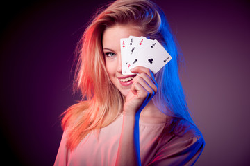 Beautiful caucasian woman with poker cards gambling in casino
