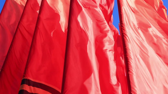 Decorative red flags waving in wind