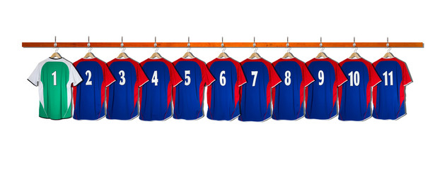 Row of Blue and Green Football Shirts hanging on wall