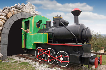 happy little girl driving a old steam locomotive