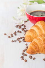 Fresh croissants with cup of hot coffee