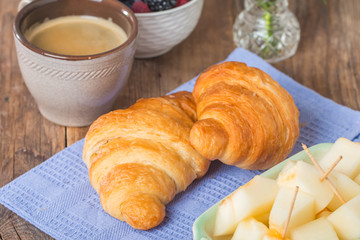 Breakfast with cup of coffee, fresh croissants