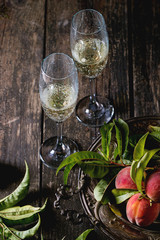 Peaches on branch with champagne