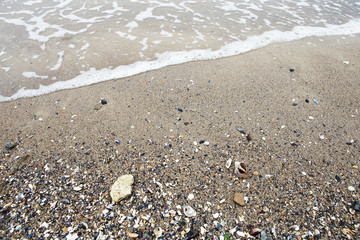 Sea wave - sand, pebbles and seashells