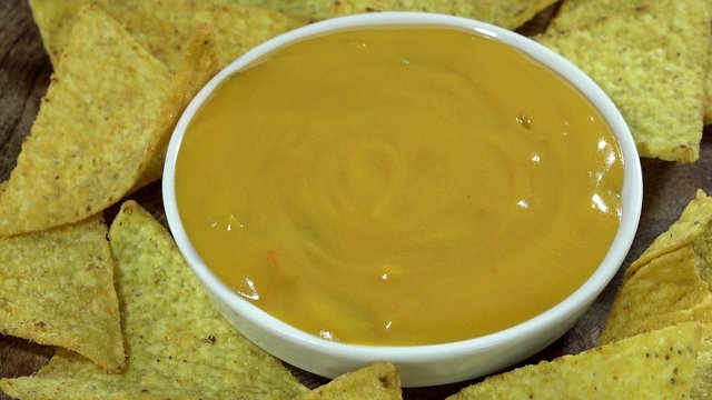 Rotating Nachos with cheese dip (seamless loopable 4K UHD footage)