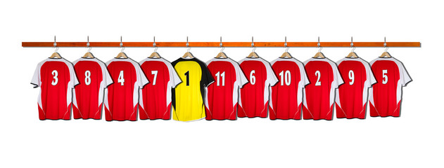 Row of Red and Yellow Football Shirts hanging on wall