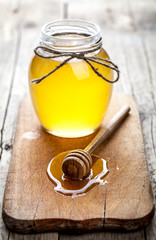 Bowl of honey on wooden table. Symbol of healthy 