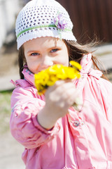 Little girl giving a bouquet