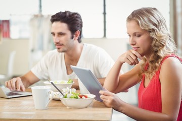 Businesswoman looking at digital tablet in office 