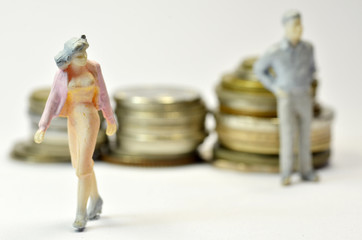 Miniature people with coins