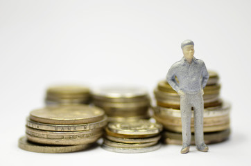 Miniature people with coins
