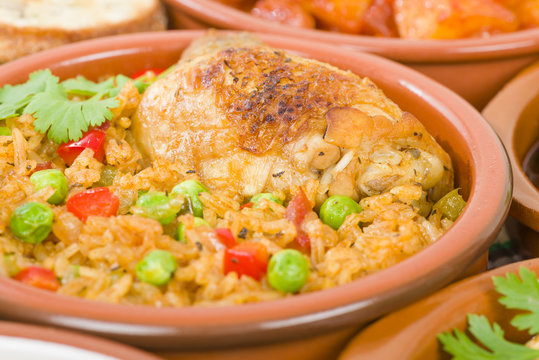 Arroz Con Pollo - Chicken and rice cooked with sofrito and beer.
