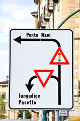Italian traffic sign showing traffic direction.
