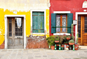 Fototapeta na wymiar Closed doors and windows of old house in Burano island. Italy.
