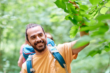group of smiling friends with backpacks hiking