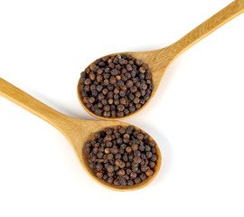 Wooden spoon and black peppercorn on white background