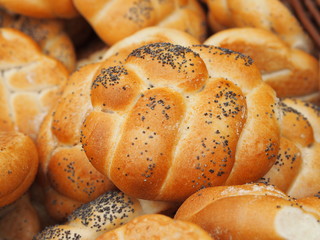 Pile of white breads buns in a bakery store.
