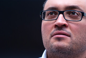 Pensive bearded caucasian man wearing eyeglass