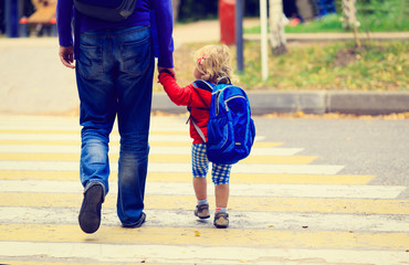 father with little daughter walking to school or daycare