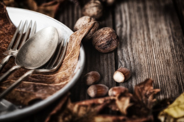 Autumn table setting with hazelnuts and walnuts
