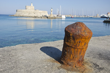 Rusty historical bollard in Greek island