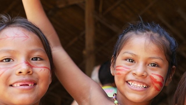 Cute native Brazilians having fun at an indigenous tribe in the Amazon