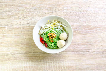 Thai Noodle with meat ball and crispy pork skin on wooden backgr