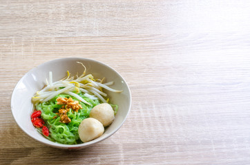 Thai Noodle with meat ball and crispy pork skin on wooden backgr