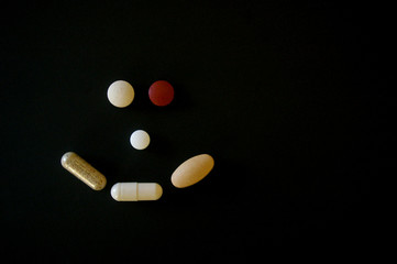 Medication pills forming a happy face