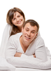 Obraz na płótnie Canvas Couple lying in bed smiling