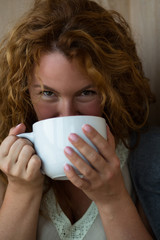 Portrait of pretty mature woman drinking tea