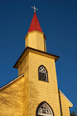 Lutheran Church in Puerto Varas, Chile. Yellow wooden building with red roof. Built circa 1923.