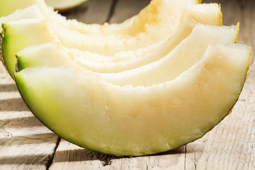 Ripe sliced  melon on a wooden background, selective focus