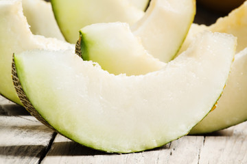Ripe sliced  melon on a wooden background, selective focus
