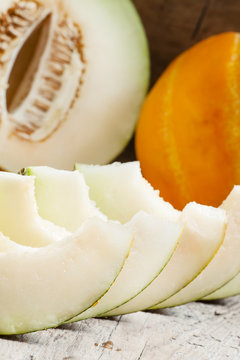 Ripe sliced  melon on a wooden background, selective focus
