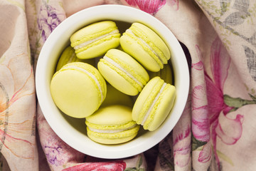 Top view of green macaroons in a bowl