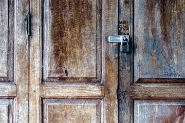Old padlock on a wooden door