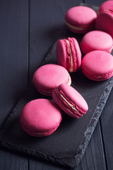 Pink raspberry macaroons on black background