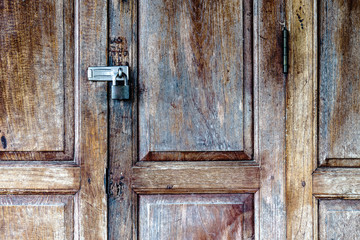 Old padlock on a wooden door