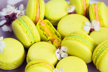 Yellow macaroons on plate, selective focus