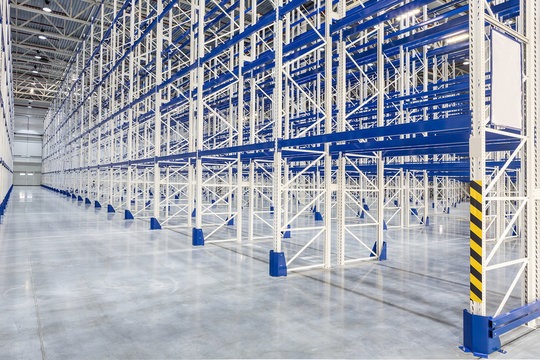 A new empty distribution warehouse with high shelves