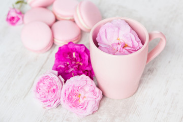 Tea cup with rose and macaroons