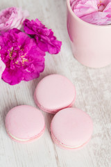 Fototapeta na wymiar Tender pink macaroons on white wood background
