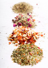 various dried herbs on wooden table