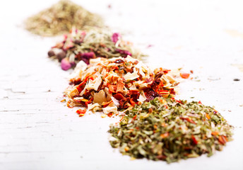 various dried herbs on wooden table